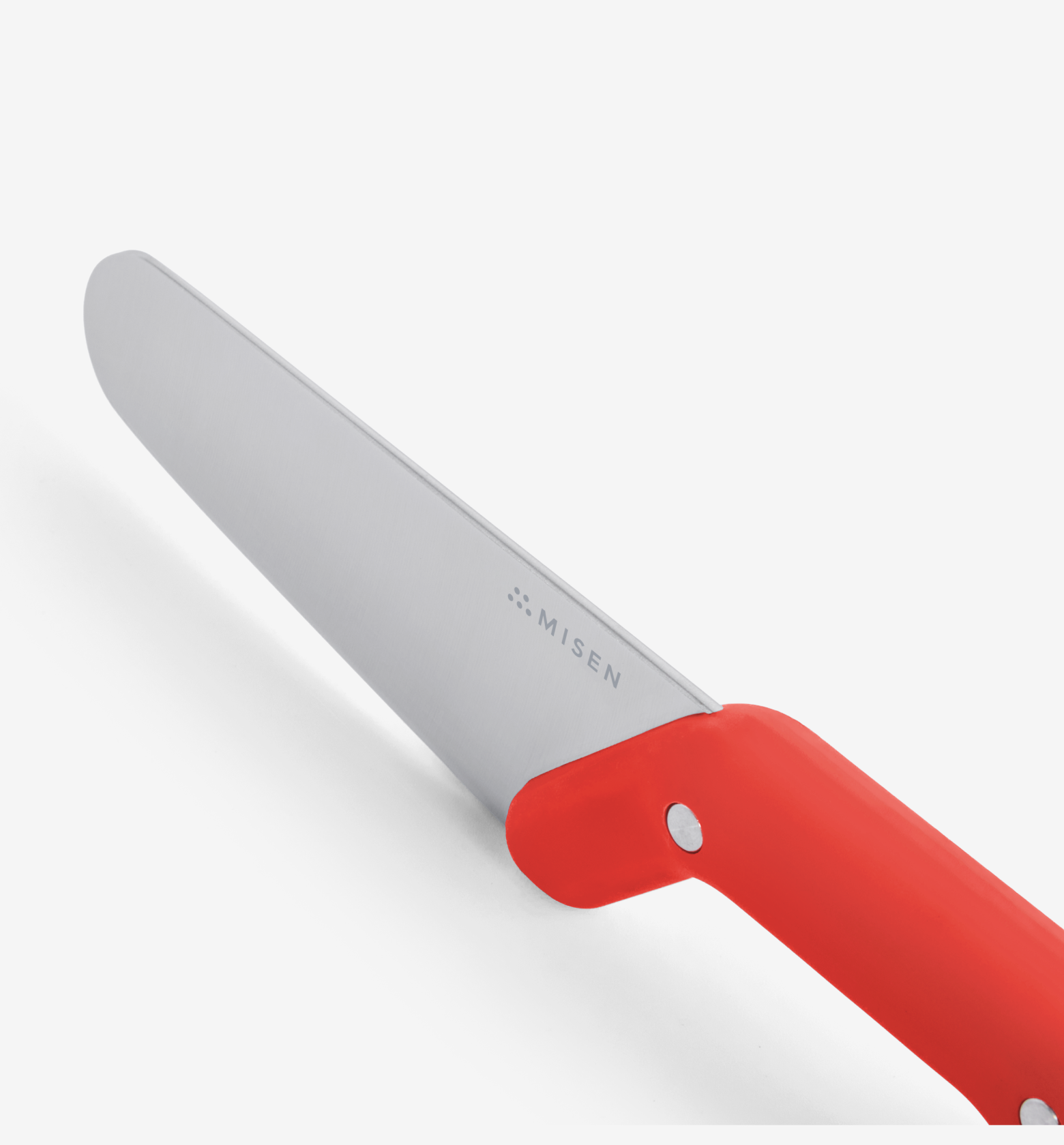 Misen kitchen knife with red handle, stainless steel blade close-up